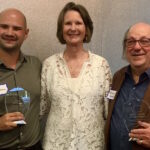 Three people posing, two with awards. Insurance Commissioner Kuderer with Andre Stackhouse (Whole WA executive director) and Ronnie Shure (Health Care for All WA president).