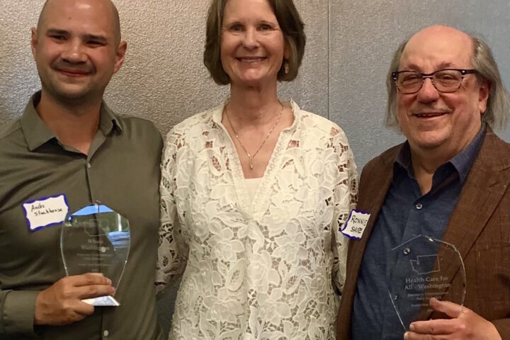 Three people posing, two with awards. Insurance Commissioner Kuderer with Andre Stackhouse (Whole WA executive director) and Ronnie Shure (Health Care for All WA president).